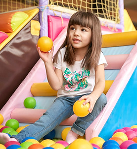 Girl playing in ball pit